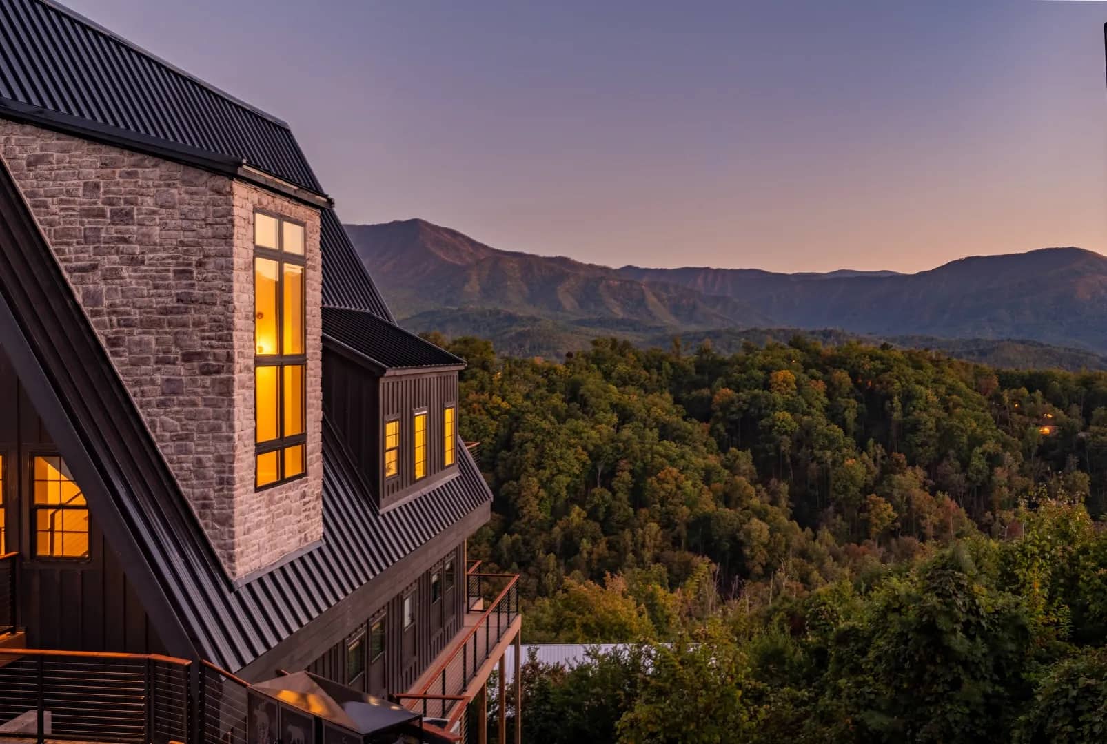 A luxury Smoky Mountain cabin at golden hour, overlooking the Great Smoky Mountains